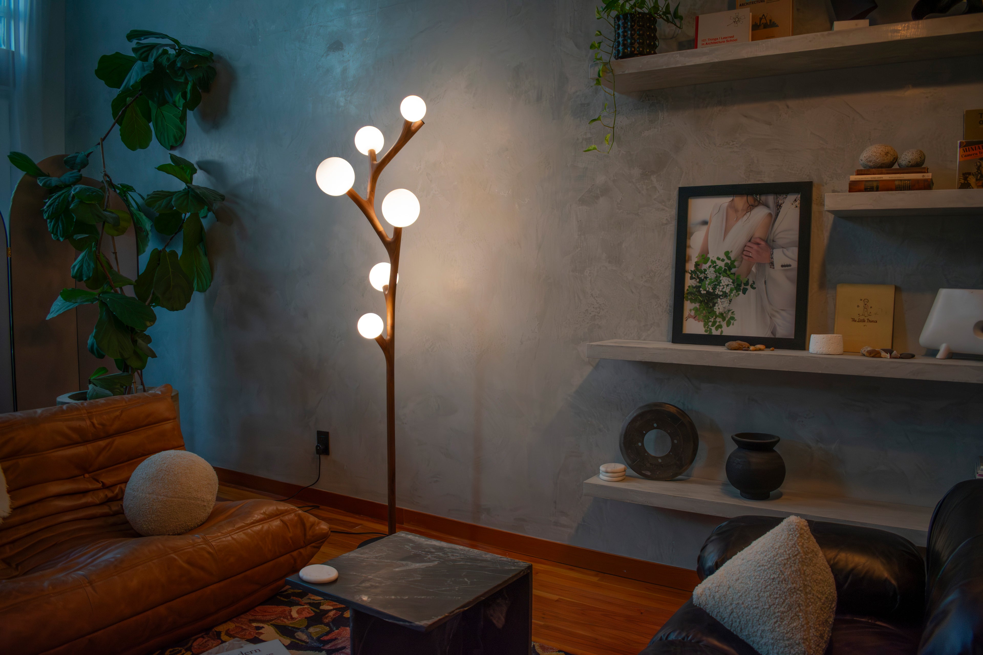 Living room with the Chaparral Floor Lamp, sofa, and decorative items.
