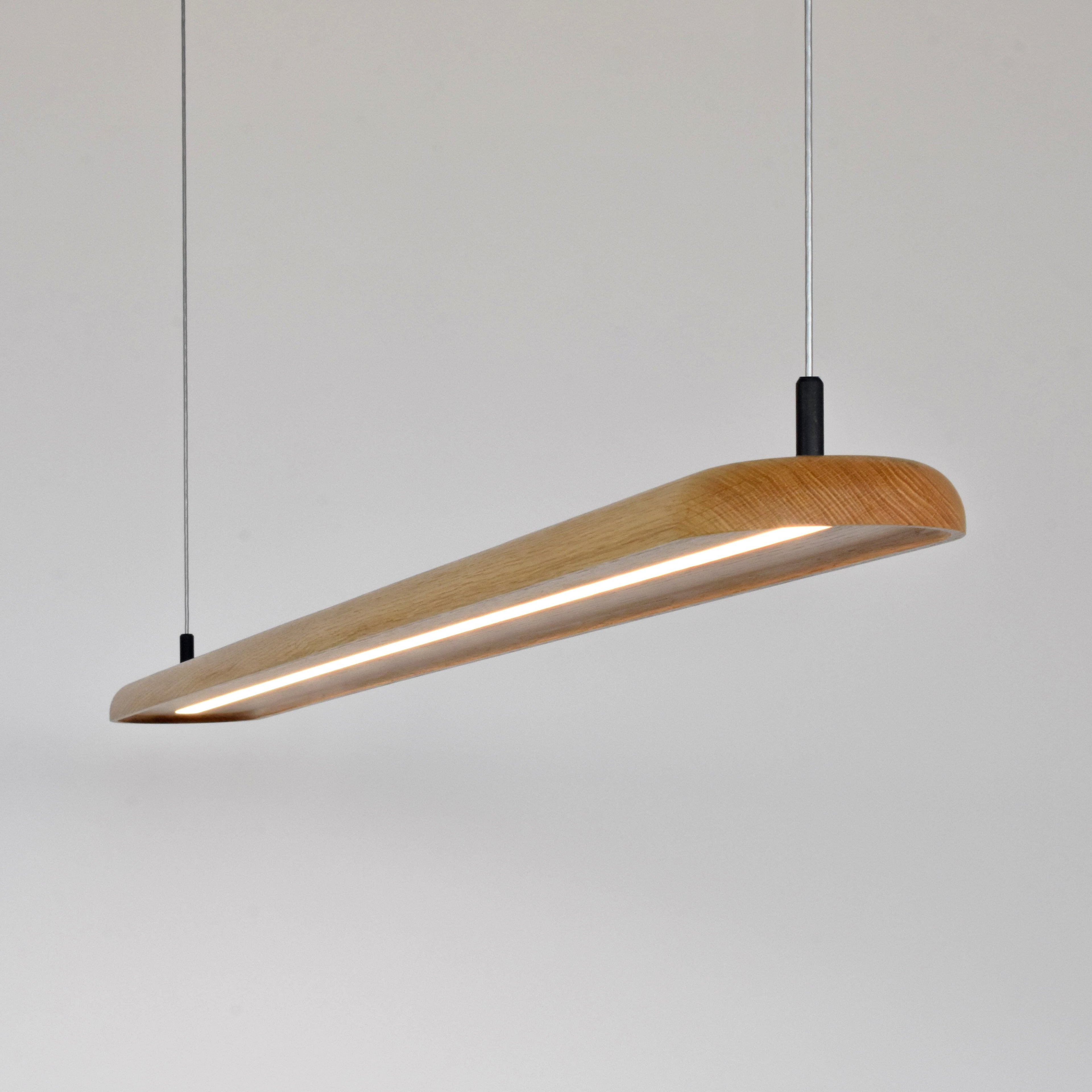 Modern Nimbus pendant light with white oakwooden finish on a plain background