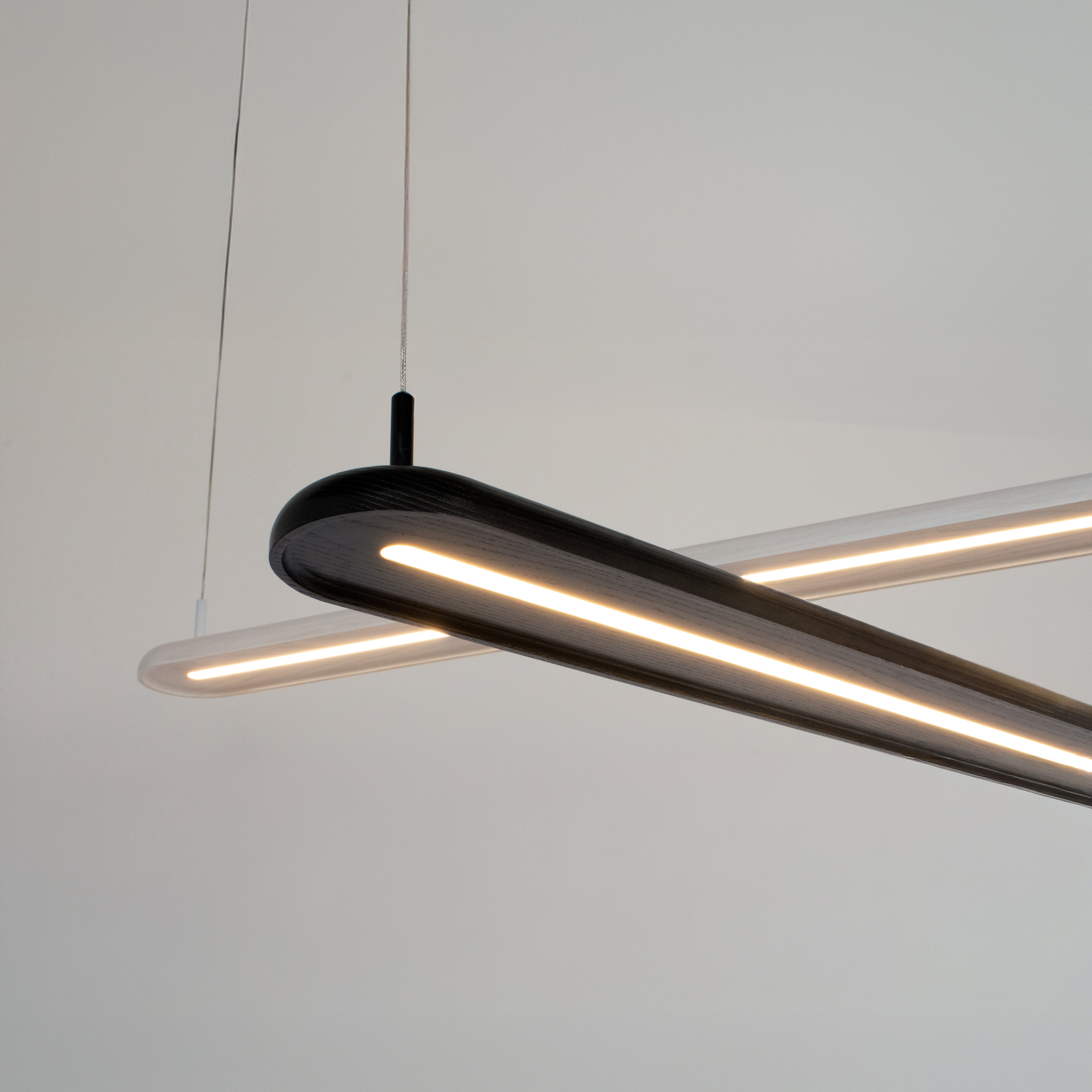 Pair of Nimbus Modern pendant light fixture in black and white on a plain background. 