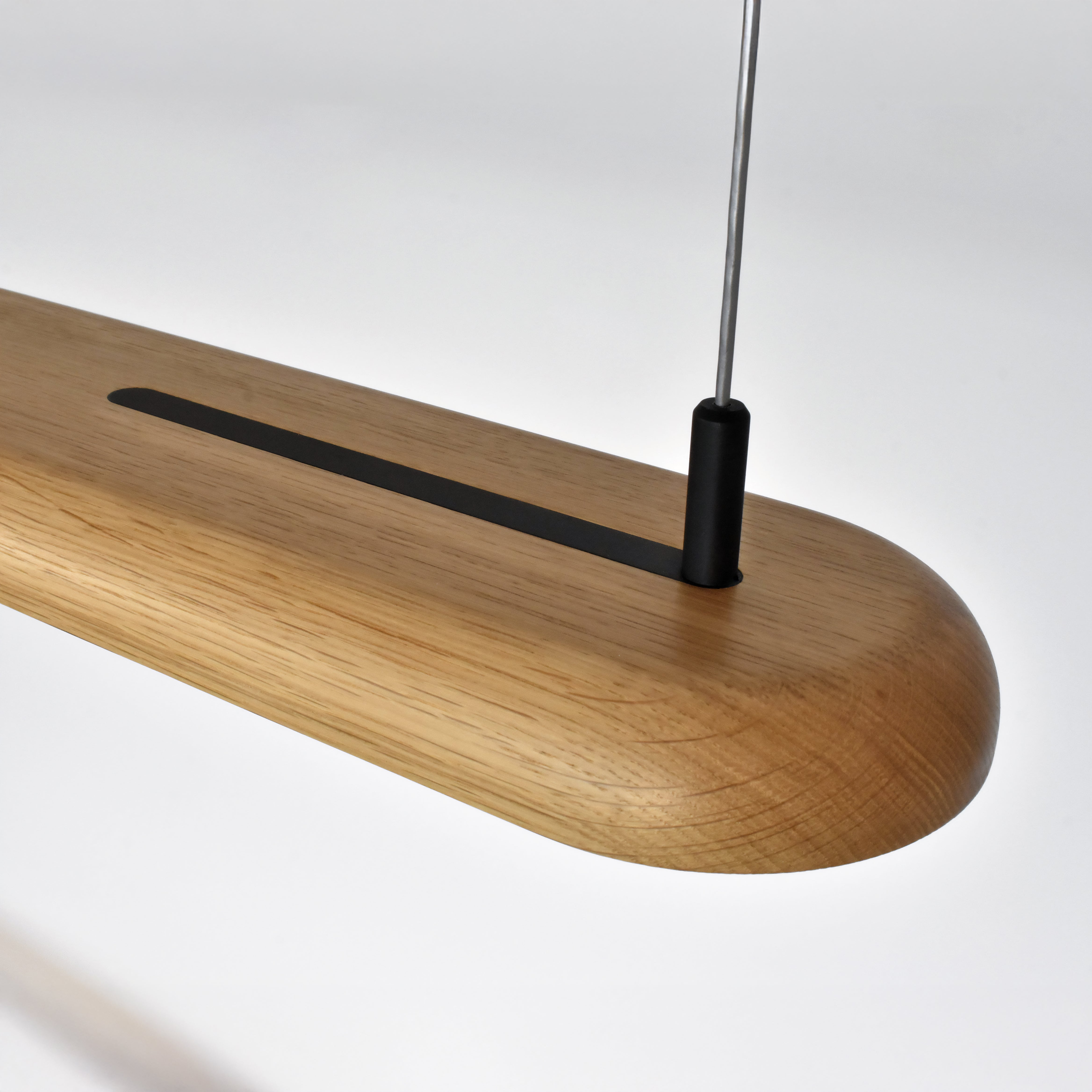 Topside detail of nimbus linear pendant showing precision machined insert part