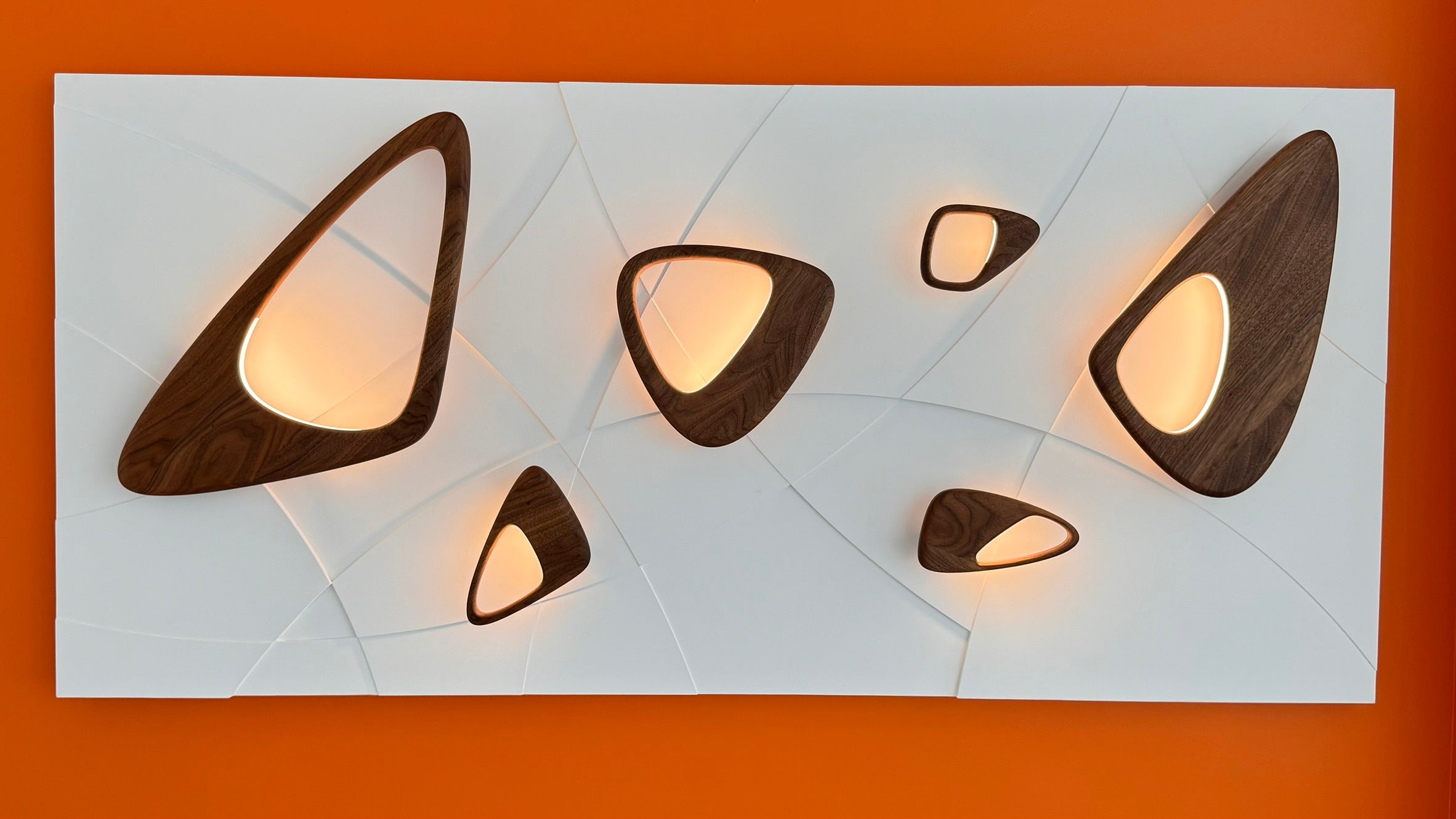 Modern wall lights with wooden accents on a white background